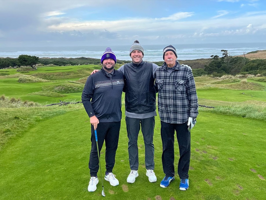 Three Men standing together on a Golf Course in Coastal Oregon