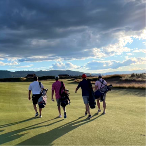 4 Men walking away from the camera on a golf course